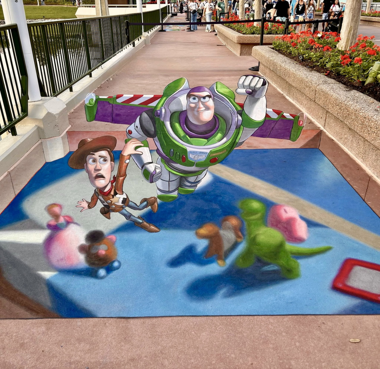 3D sidewalk chalk art of Buzz Lightyear and Woody creating optical illusion on pavement