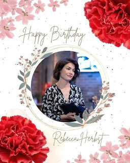 Birthday card with a woman's portrait framed by pink blossoms and red flowers