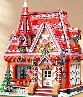 Colorful toy building block gingerbread house with red roof, candy cane decorations and festive details