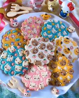 Plate of pastel Sanrio character cookies with colorful sprinkles and cute animal faces
