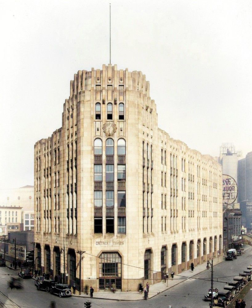 Art Deco Detroit Times Building with ornate limestone facade, clock, and stepped tower in downtown Detroit