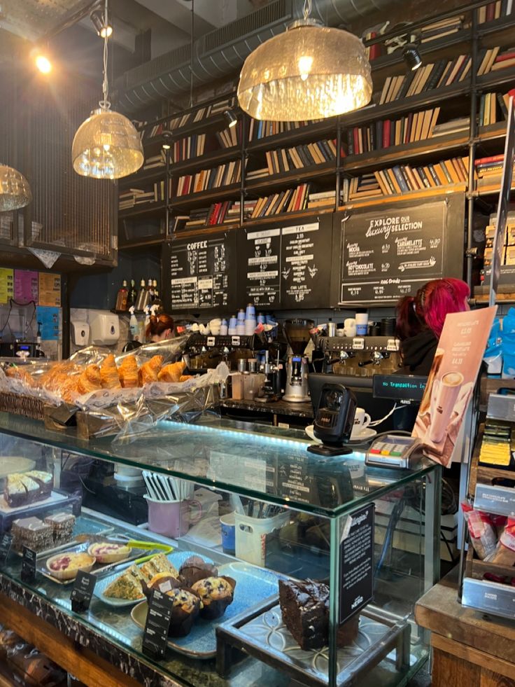 Cozy coffee shop interior with wooden tables, warm lighting, and a pastry counter