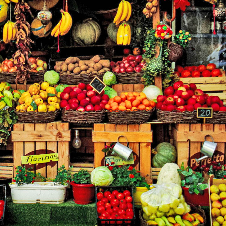 Colorful outdoor market stand filled with baskets of fresh fruits and vegetables