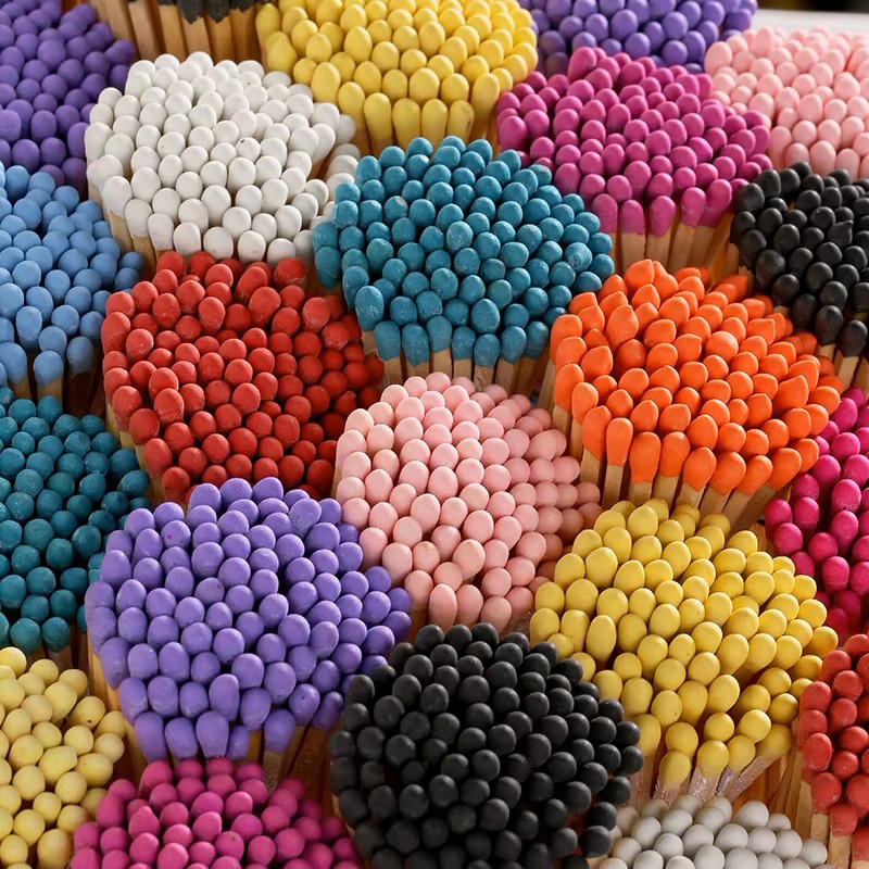 Colorful matchsticks with round heads arranged in circular clusters forming a vibrant mosaic pattern