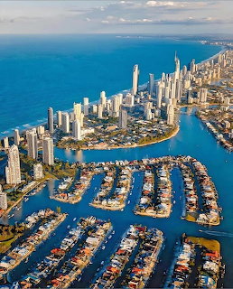 Aerial view of Gold Coast Australia with skyscrapers, marina, and ocean coastline