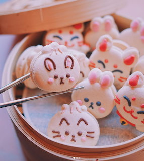 Cute animal-shaped macarons shaped like bunnies, cats, and bears in bamboo steamer baskets
