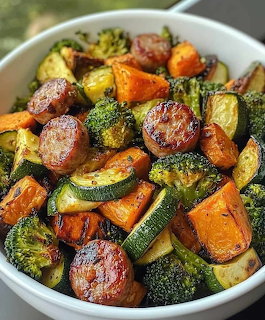 Bowl of roasted vegetables with broccoli, carrots, zucchini, and sausage pieces