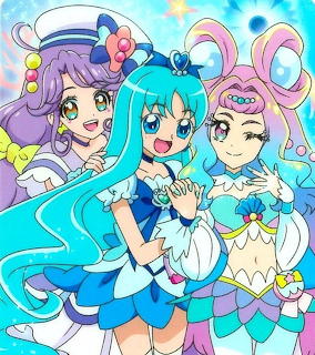 Three anime magical girls in blue, purple, and pink outfits with long hair and star decorations