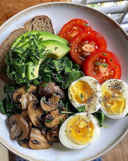 Breakfast bowl with tomatoes, soft-boiled eggs, mushrooms, spinach, avocado, and whole grain bread