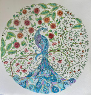 Colorful circular mandala with peacock and floral patterns