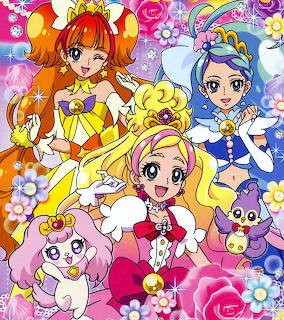 Colorful Precure anime magical girls in costume with fairy mascots and flower decorations