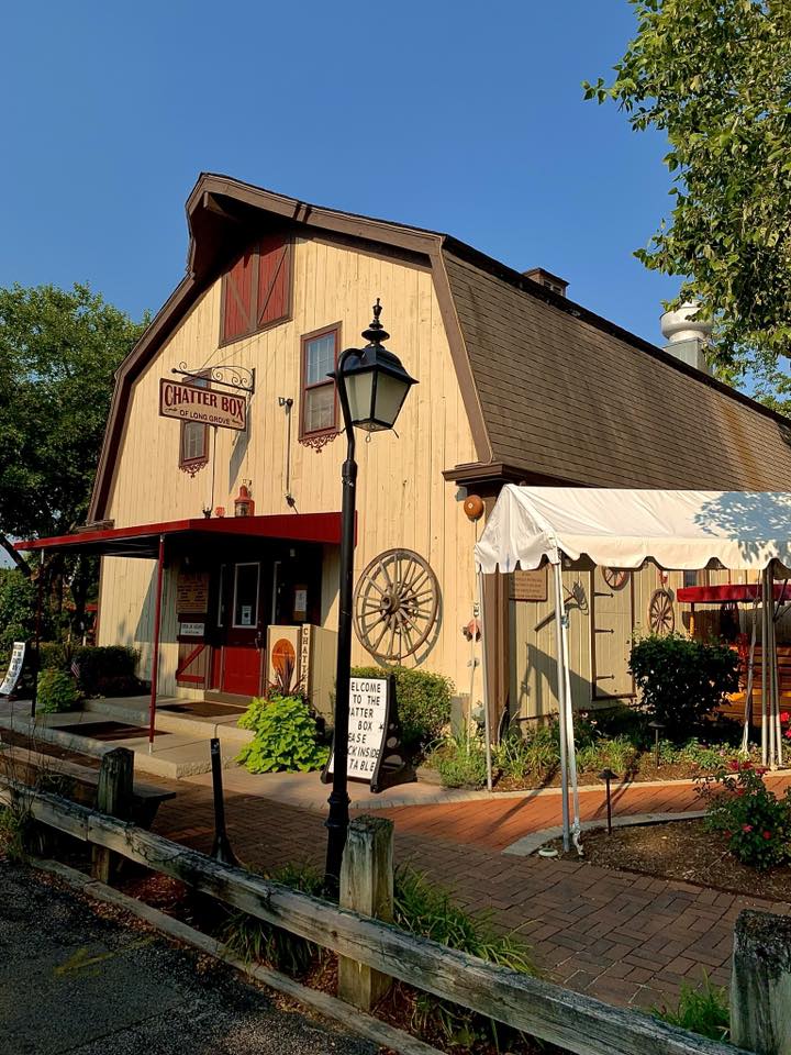 Rustic barn-style restaurant with wooden deck and lamp post in Long Grove