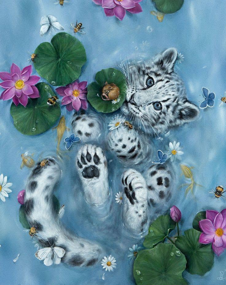 Spotted cat floating on back in water with pink lotus flowers and lily pads