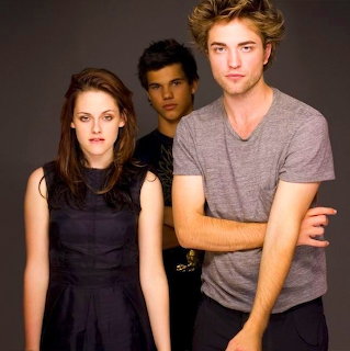 Three Twilight characters posing together in a studio portrait against a dark background