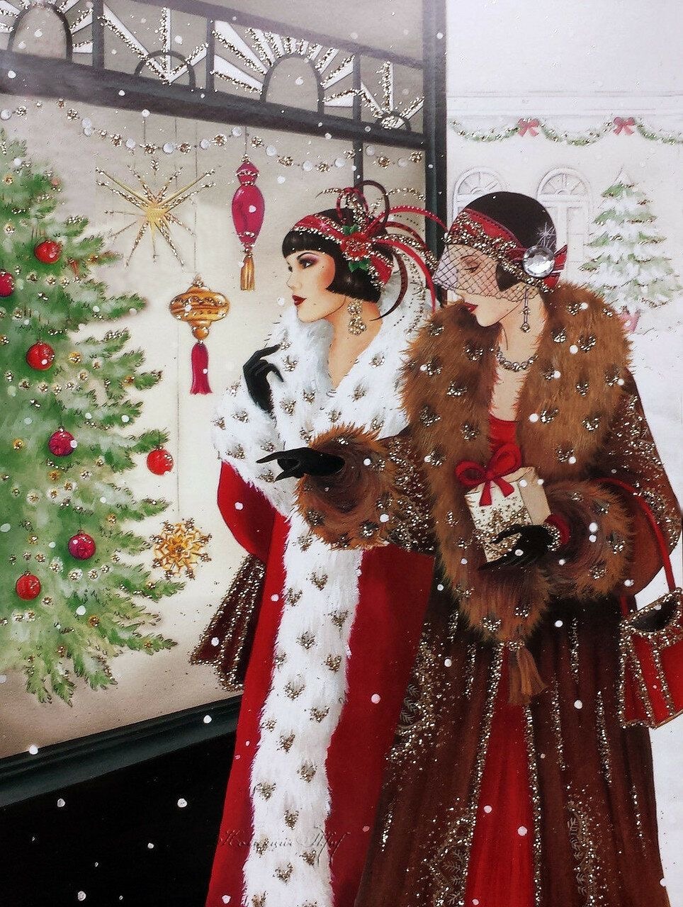Two women in Art Deco fashion with ornate headpieces standing by a Christmas tree with falling snow