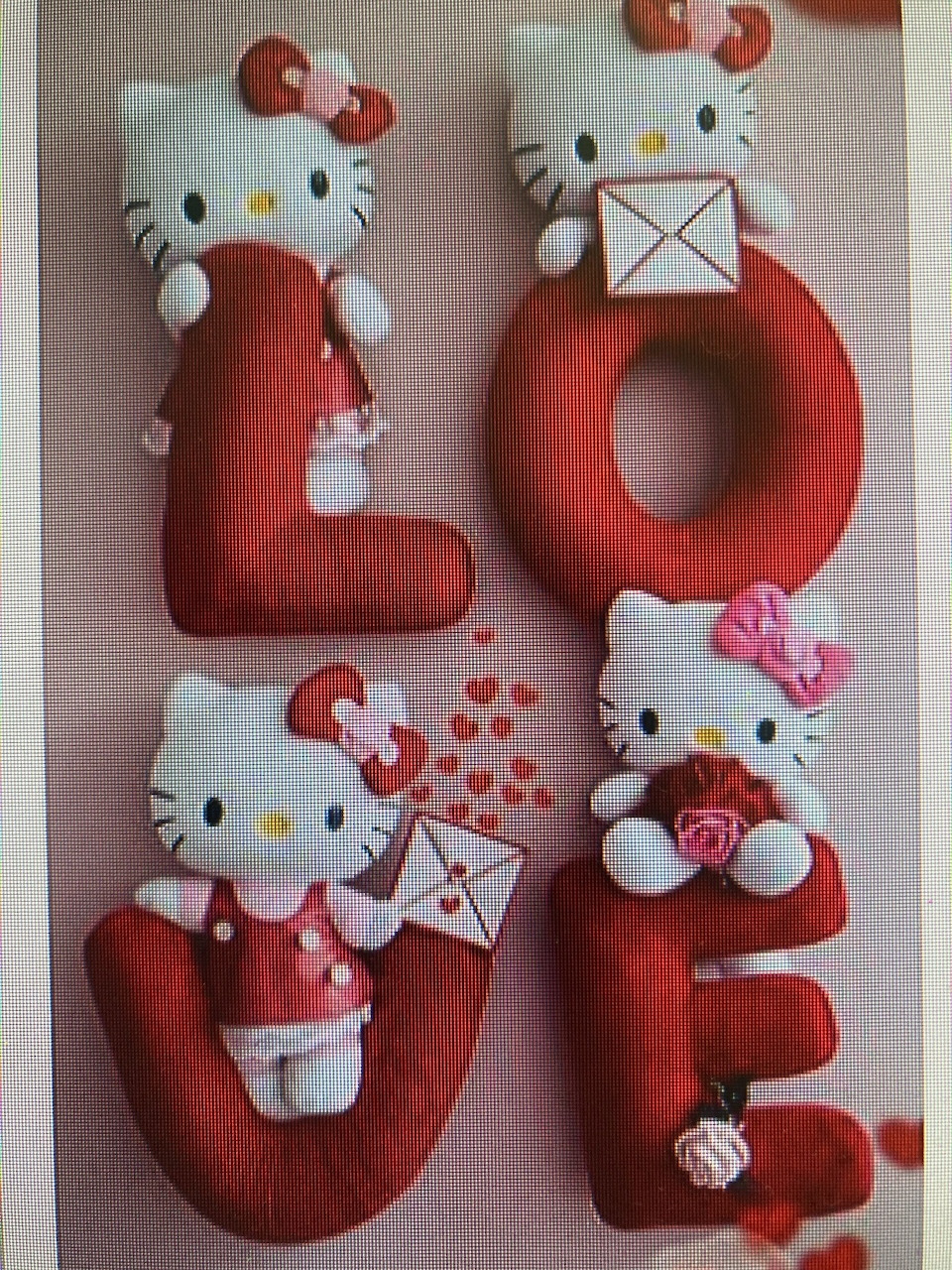 Plush Hello Kitty characters posed on large red LOVE letters with hearts and envelopes