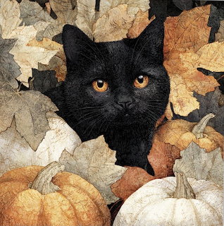 Black cat with golden eyes nestled among pumpkins and autumn leaves
