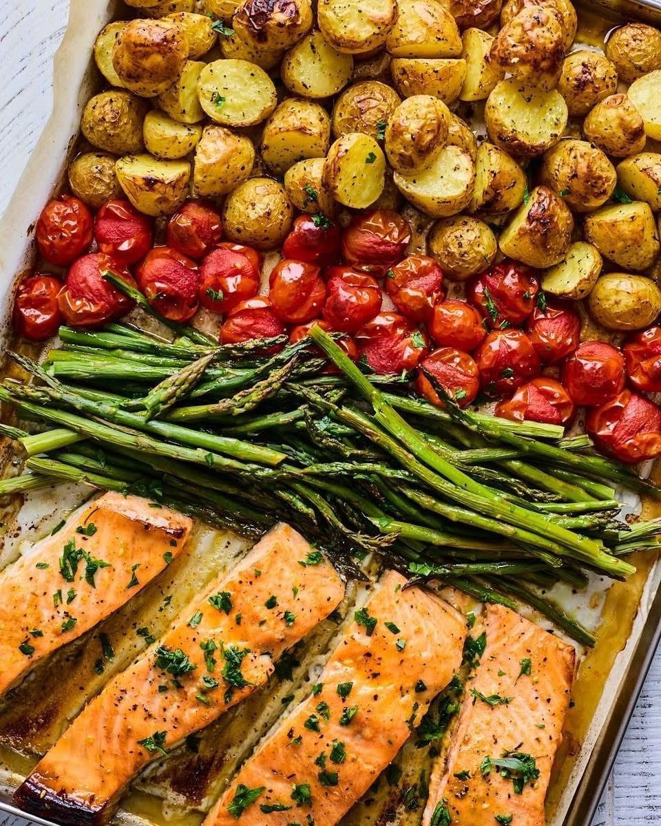Sheet pan meal with salmon, roasted potatoes, tomatoes and asparagus