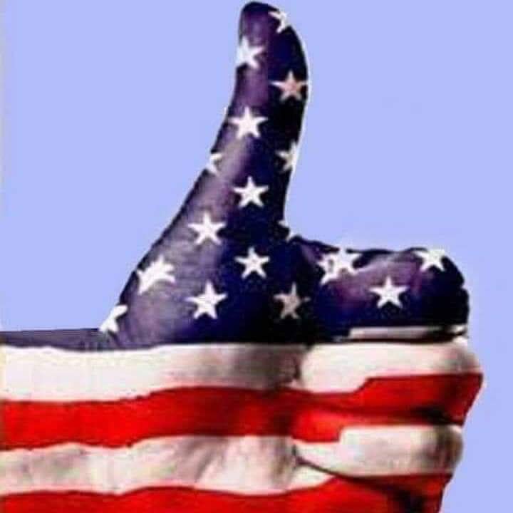 Hand giving a thumbs-up painted like the American flag against a light blue background