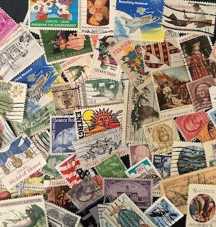 Overlapping collection of vintage postage stamps from different countries in various colors and designs