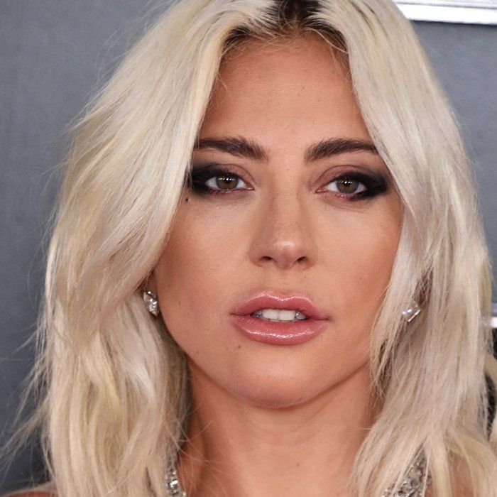 Close-up portrait of Lady Gaga with blonde hair and smoky eye makeup