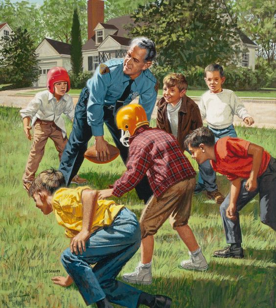 Police officer playing football with children on a residential street lawn