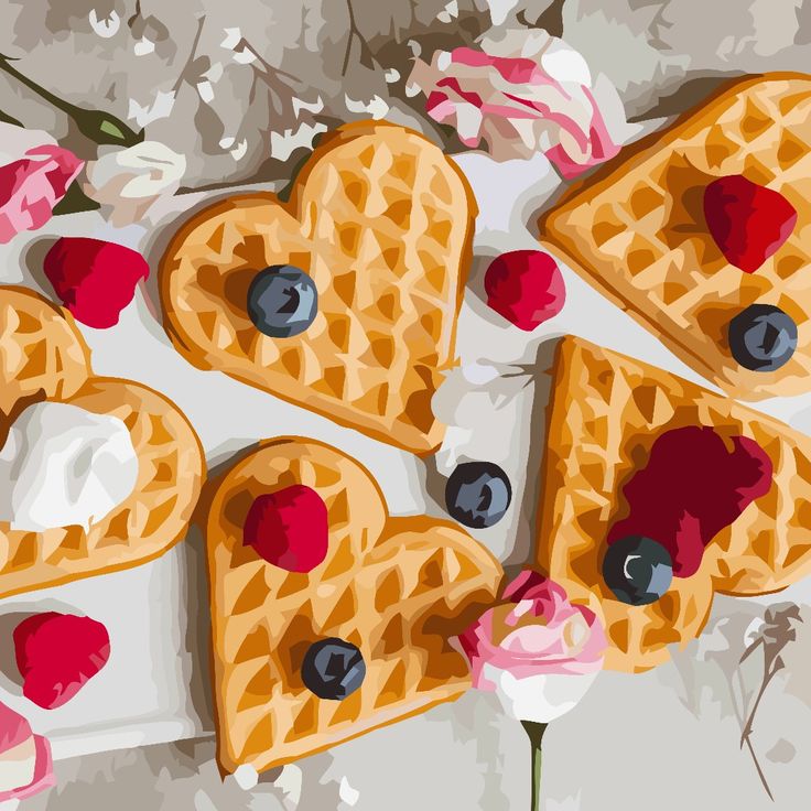 Heart-shaped waffles with berries and whipped cream on white wood