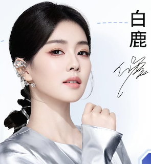Young Asian woman with braided dark hair and crystal ear cuff jewelry in a portrait photo
