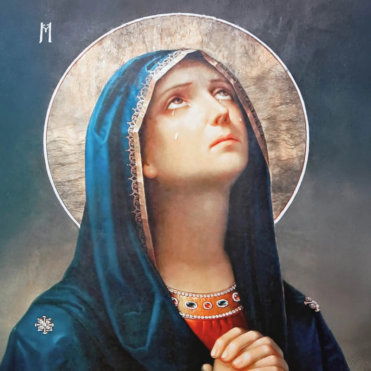 Painting of Our Lady of Sorrows praying with folded hands, blue veil, and halo