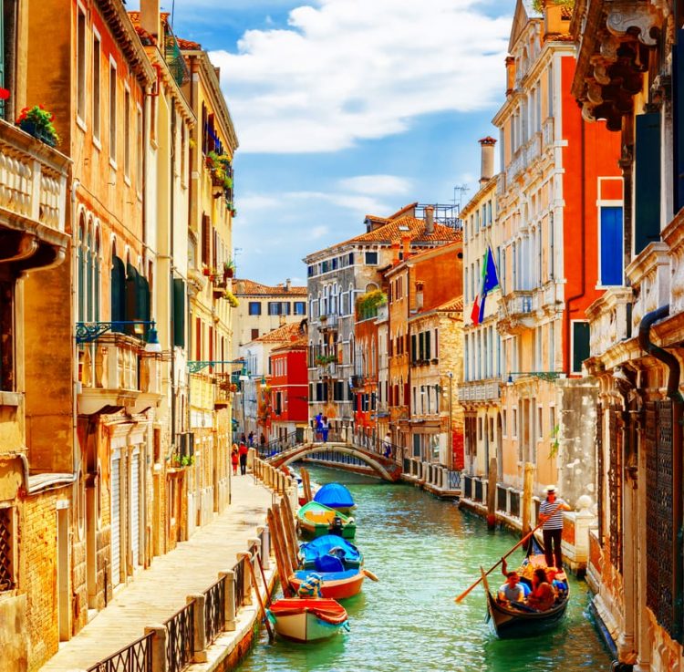 Vibrant canal scene in Venice with colorful buildings and gondolas on turquoise water