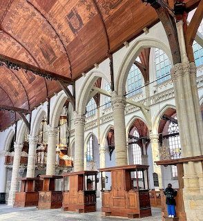 Interior view of historic church with vaulted wooden ceiling and Gothic stone arches