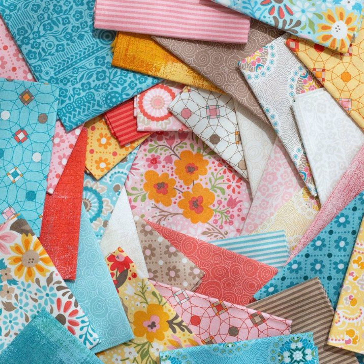 Colorful patterned paper pieces scattered in a patchwork arrangement