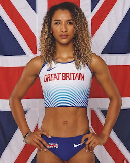 Female athlete in Great Britain uniform standing before Union Jack flag