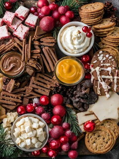 Christmas dessert board with cookies, chocolate, cranberries, and pine decorations