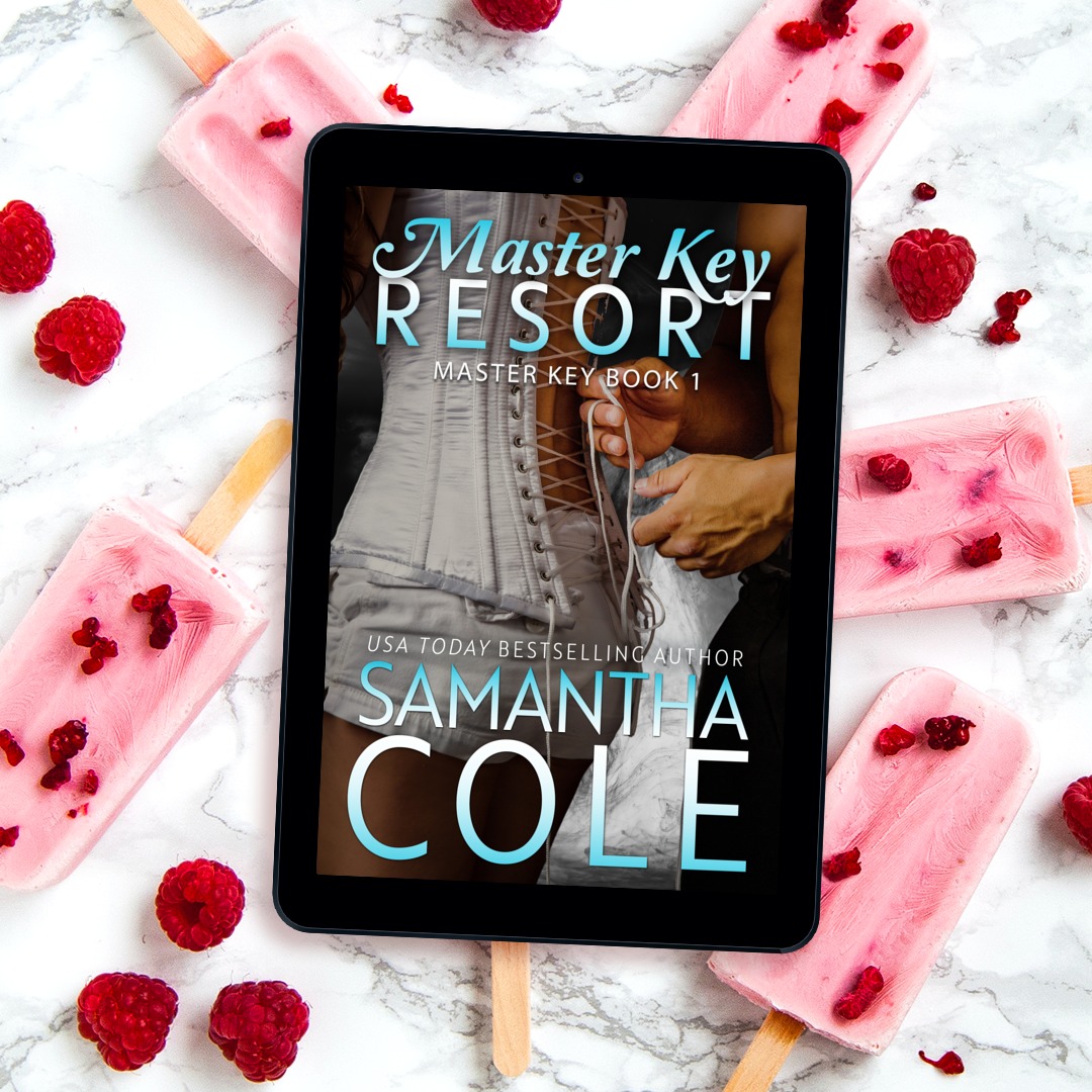 Tablet with a book cover on marble, surrounded by pink popsicles and raspberries