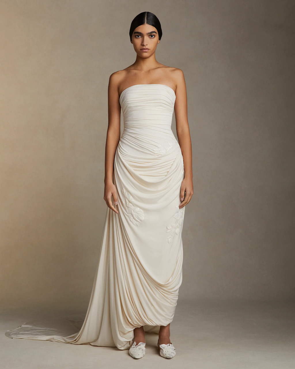 Bride in white designer wedding gown posing in studio