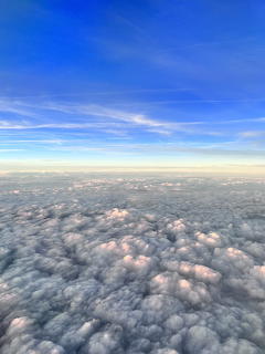 Aerial view of sunset clouds with blue sky and golden horizon
