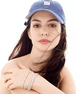 Portrait of Anne Hathaway in blue cap with long brown hair