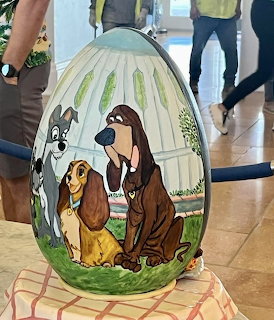 Large painted Easter egg with Lady and the Tramp Disney characters on display in a hotel lobby