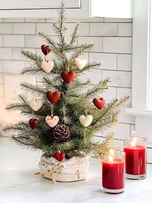 Small Christmas tree with red and white ornaments and candles