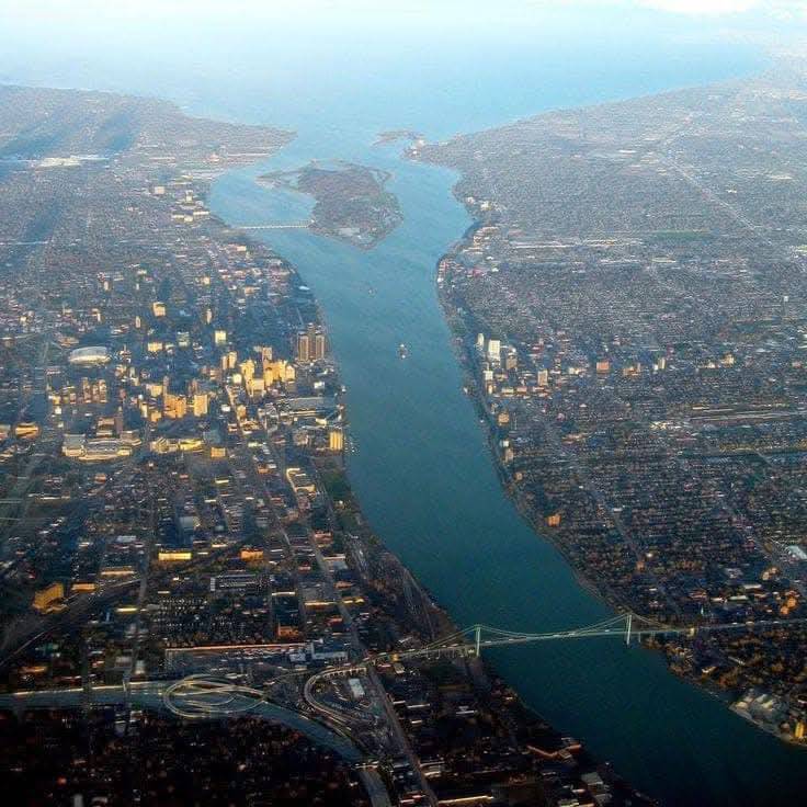 Aerial view of the Detroit River between Detroit and Windsor with Belle Isle in the center