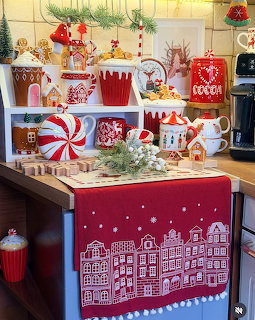 Christmas-themed kitchen counter decorated with red and white holiday dishes, candy canes, and festive ornaments