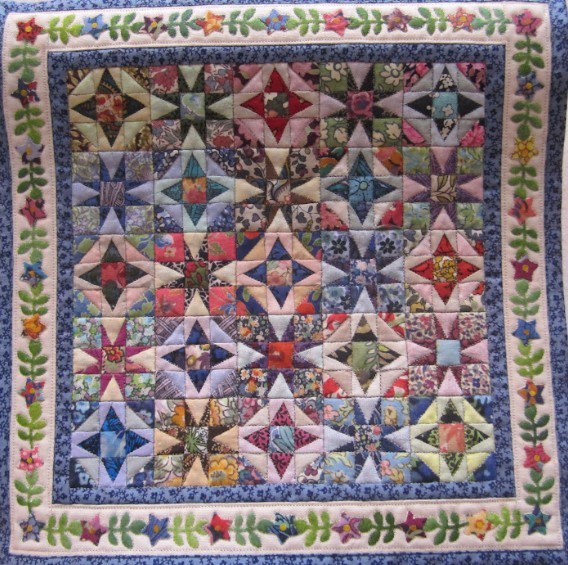 Colorful patchwork quilt with star patterns and floral border