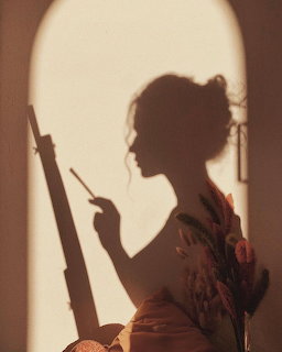 Silhouette of woman in profile holding object in arched doorway with warm backlight