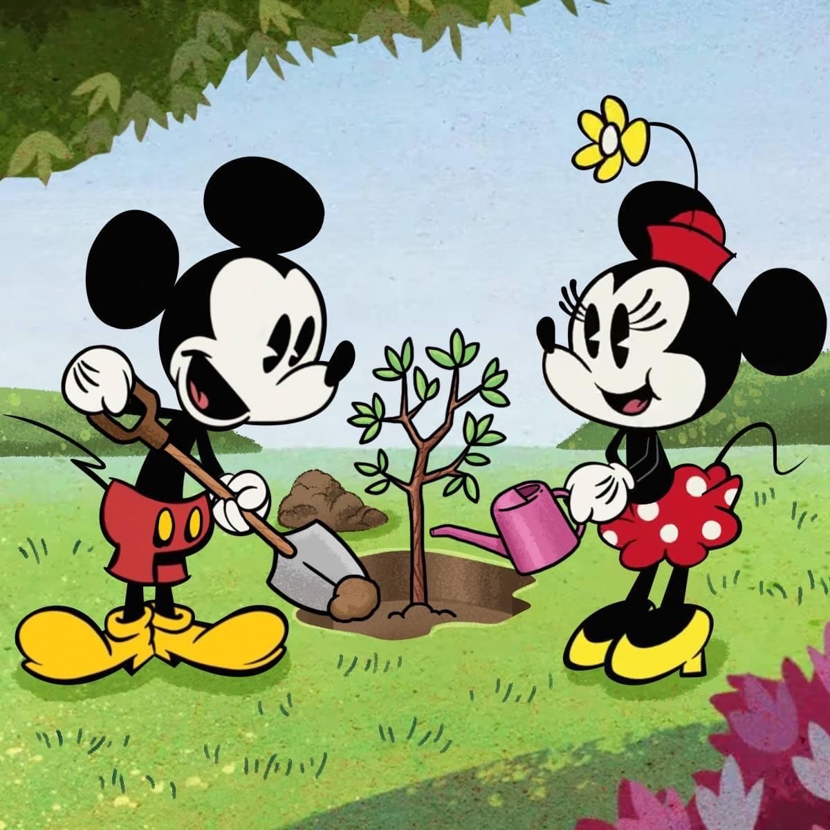 Mickey and Minnie Mouse planting a small tree in a garden with watering can and flowers