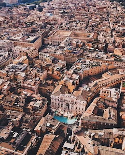 Aerial photograph of Rome city center with dense historic buildings and teracotta rooftops
