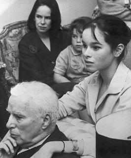 Black and white family portrait of Charles Chaplin with wife and children in close grouping