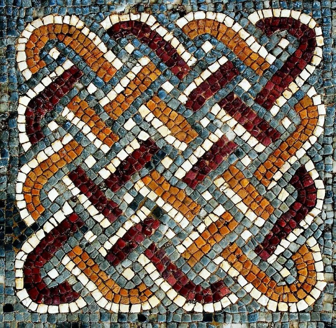 Colorful stone mosaic with interwoven Celtic knot pattern in red, orange, white and green tiles