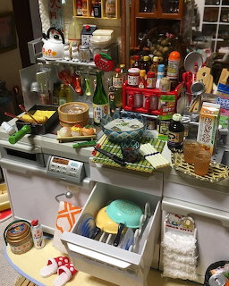 Holiday dessert buffet with decorated cakes, festive treats, and miniature Christmas village buildings