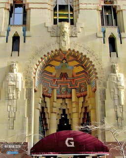 Ornate Art Deco entrance archway with colorful geometric mosaic and burgundy awning at Guardian Building Detroit